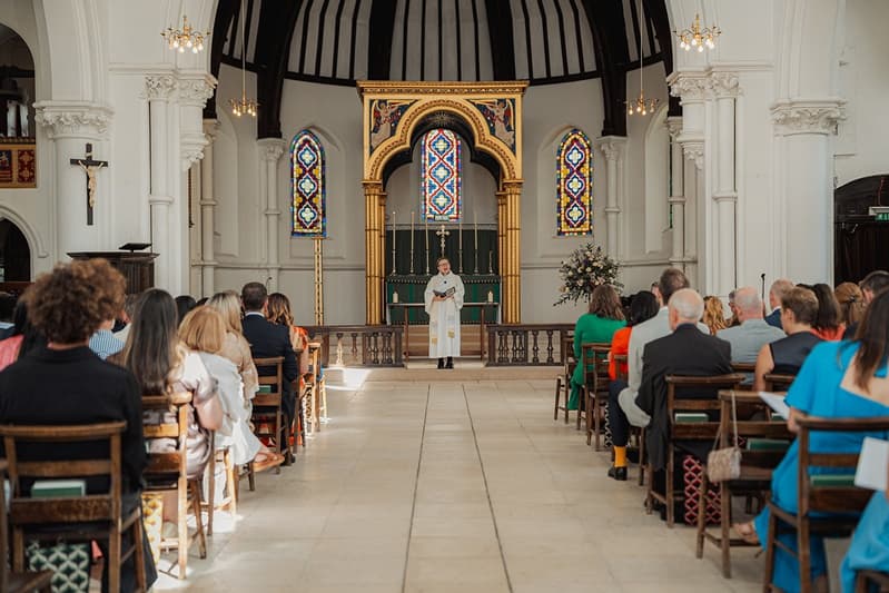 View down the aisle towards the gilded reredos and stained glass at St John’s Church, East Dulwich