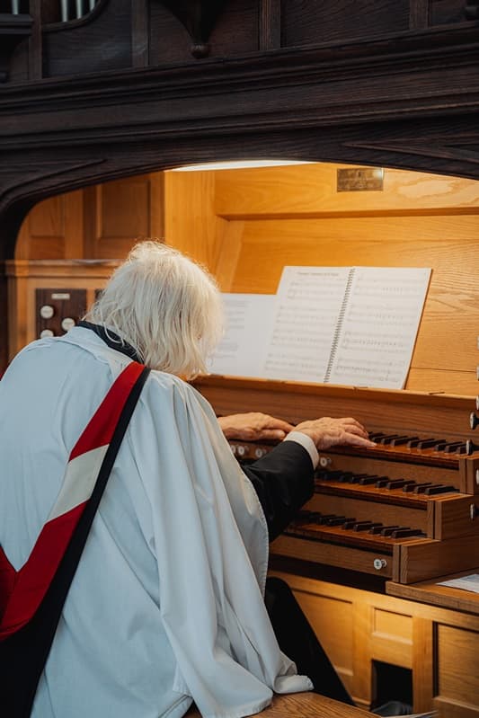 The organist playing the timber pipe organ at St John’s Church, East Dulwich