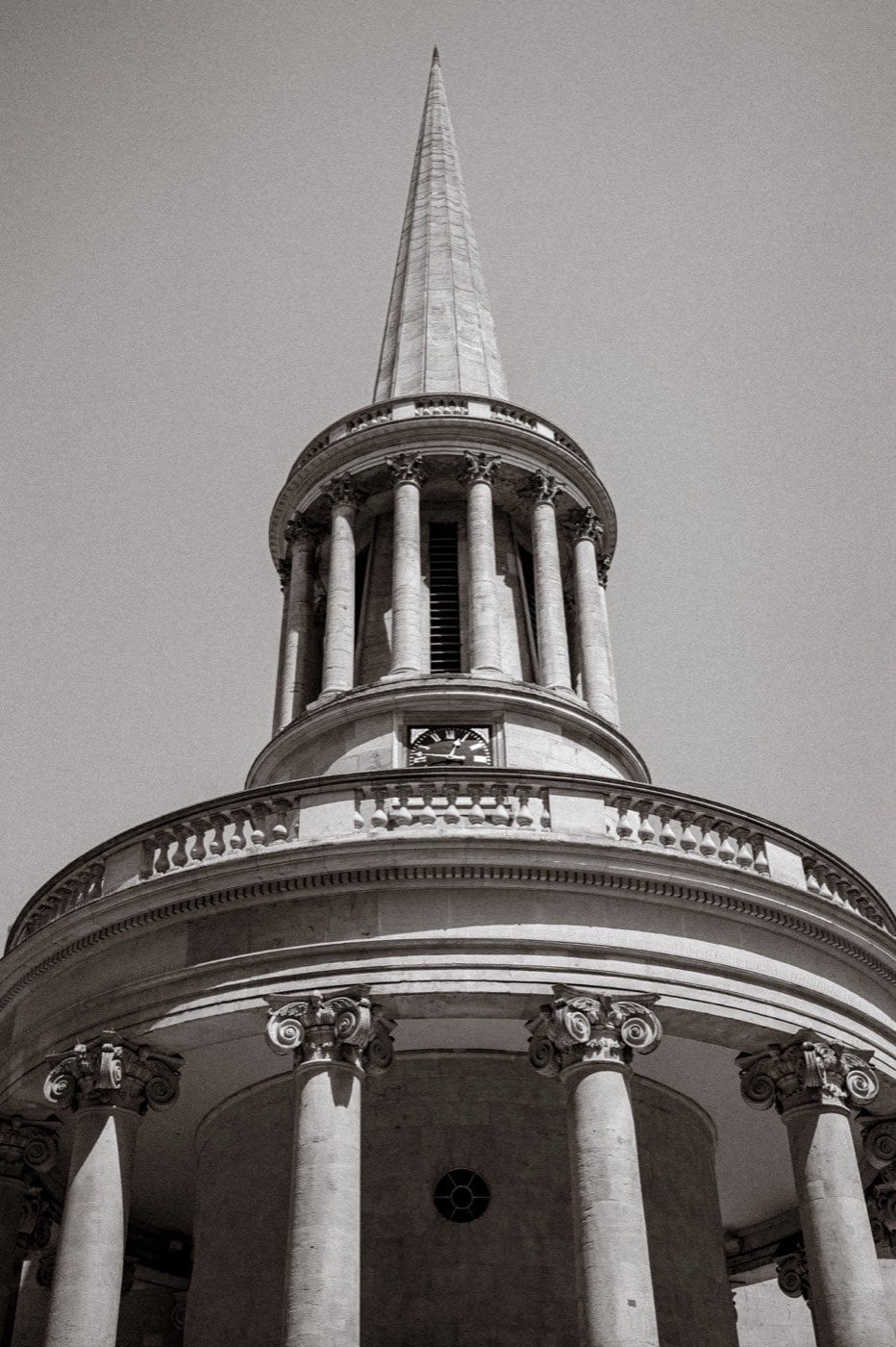 Black and white photograph looking up at the rotunda and spire of All Souls, Langham Place