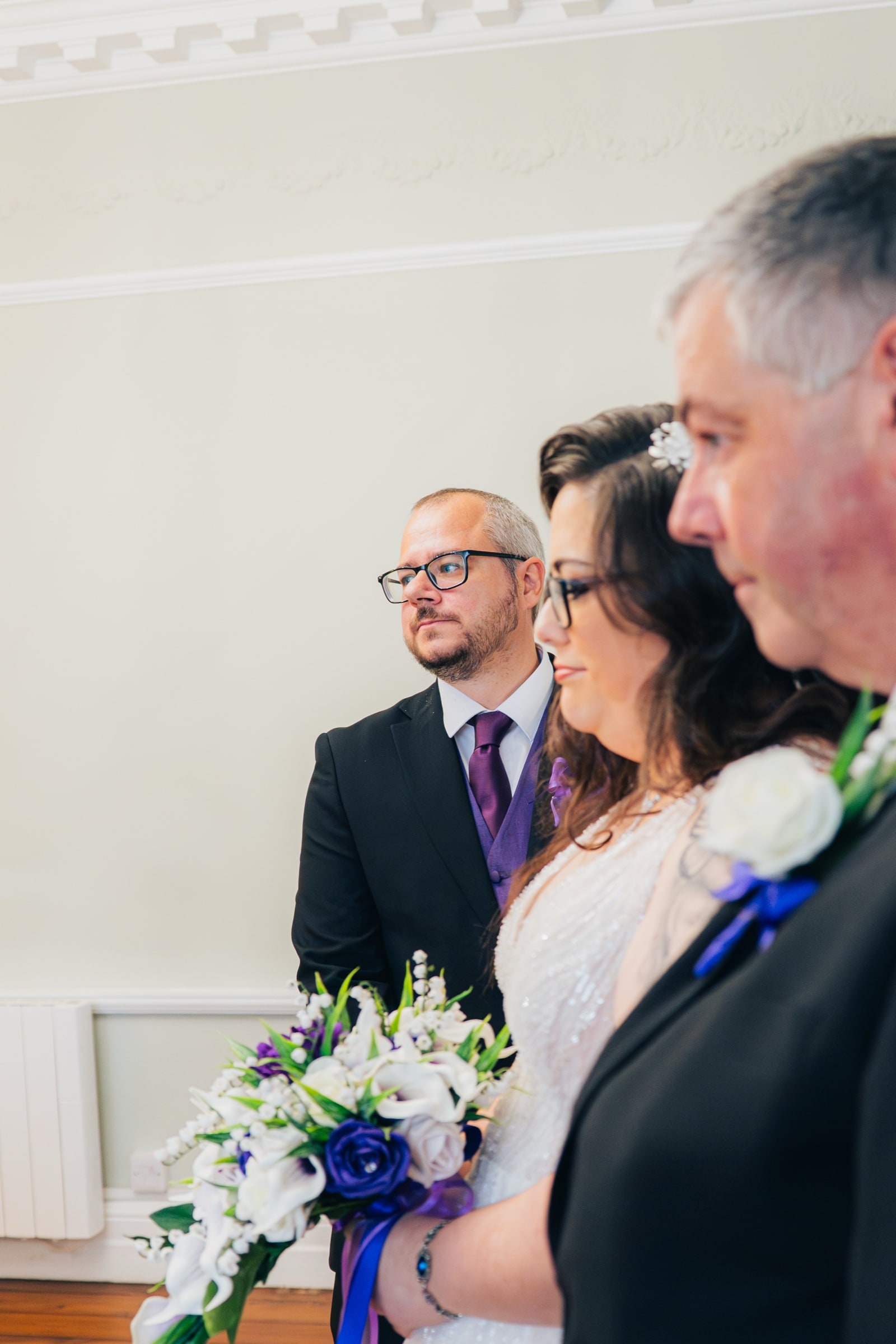 Groom watching the bride enter on her father’s arm during the ceremony at Ashton Lodge Country House