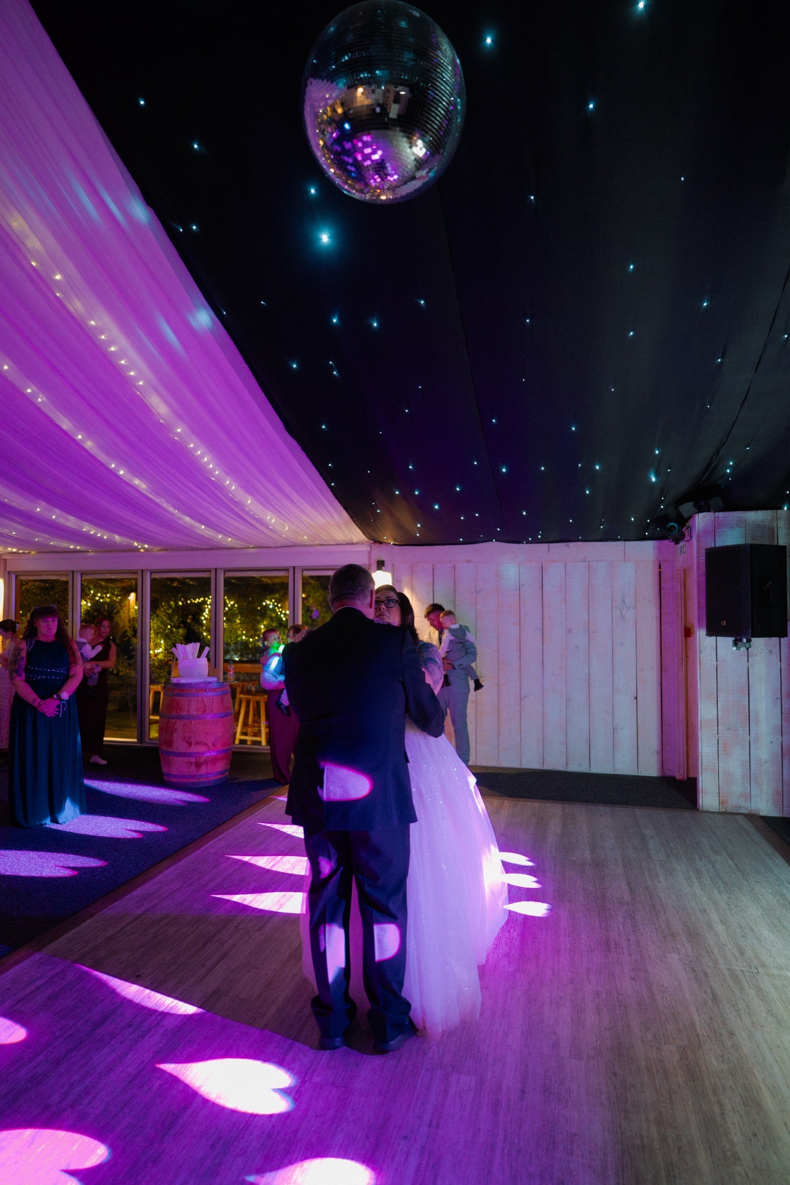 The couple’s first dance under a mirror ball in the fairy-lit marquee at Ashton Lodge Country House