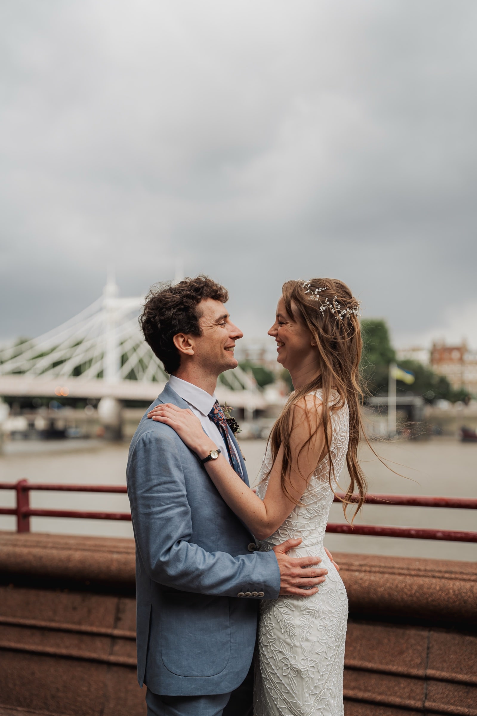 A wedding couple beside Albert Bridge in South West London