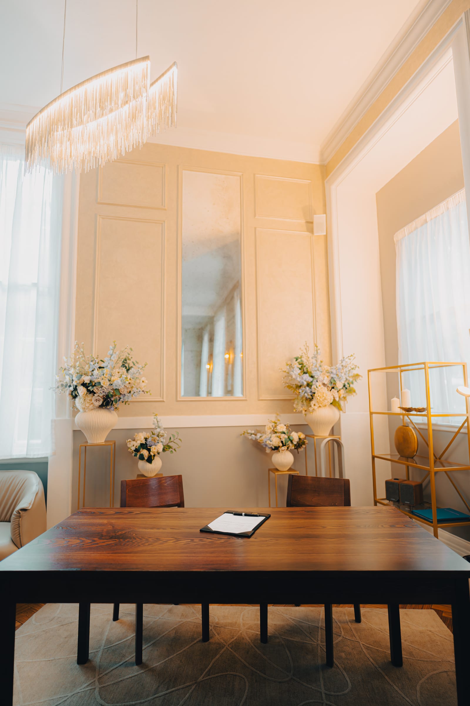 The registrar’s table and chandelier in a daylit ceremony room at Chelsea Old Town Hall