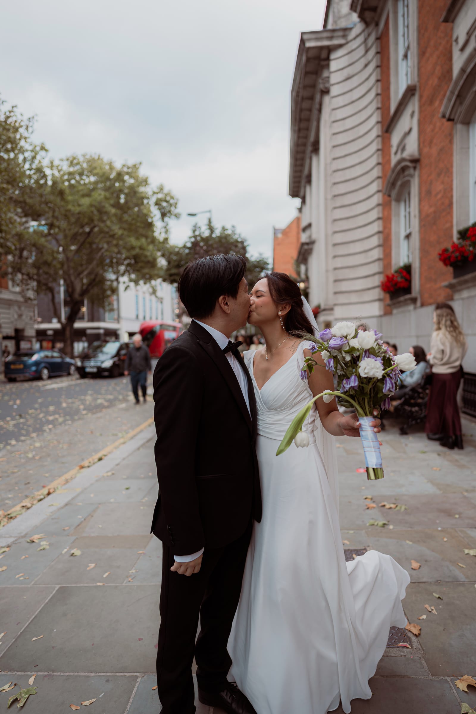 A newly married couple walking the King’s Road after their Chelsea Old Town Hall wedding