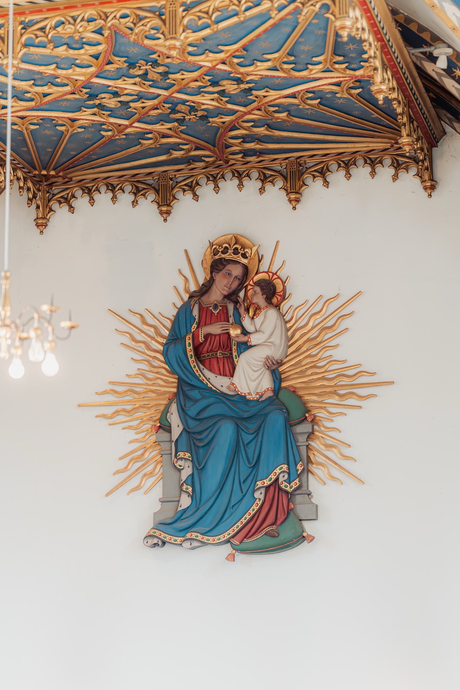 A painted and gilded Madonna and Child figure beneath a Gothic canopy inside St John’s Church, East Dulwich