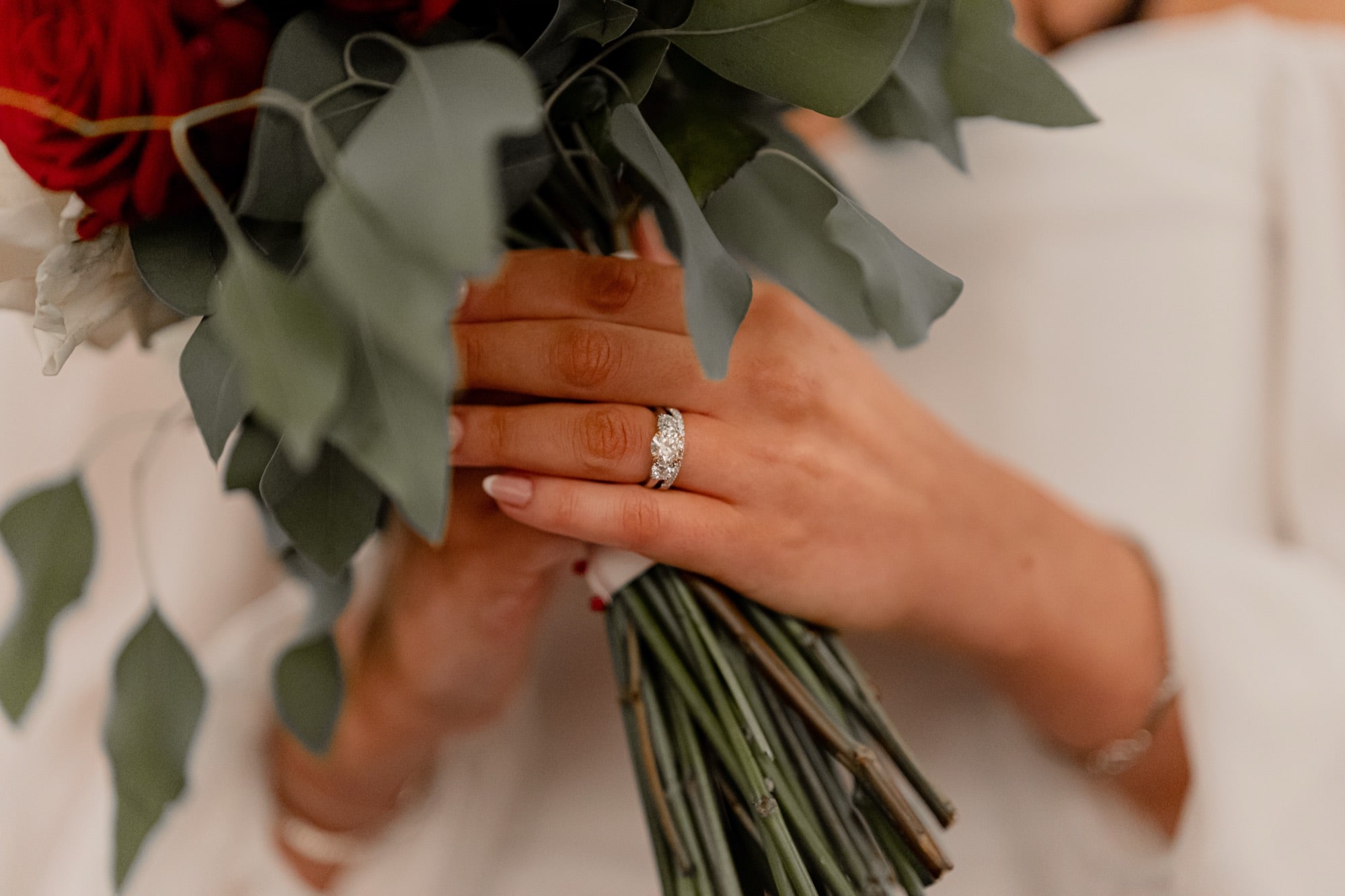 Wedding rings resting on a bouquet, photographed in natural light