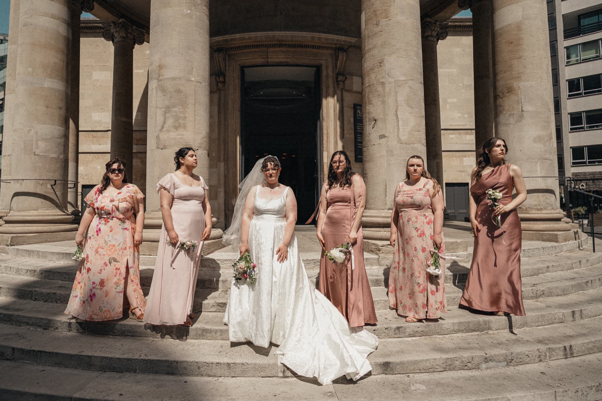 Bride with her bridesmaids on the steps of the All Souls, Langham Place portico