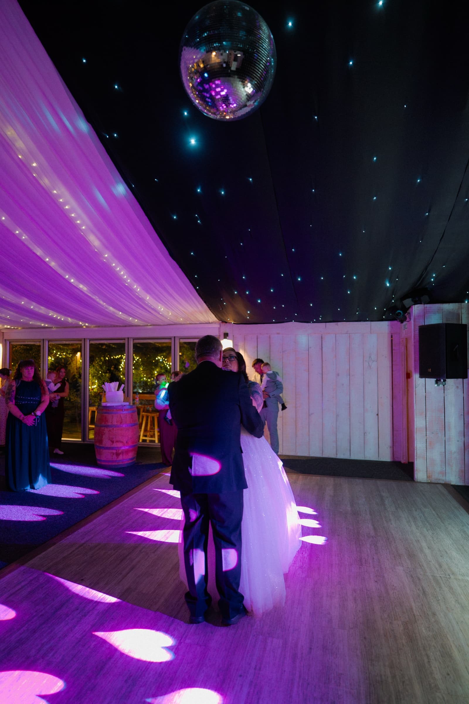 The couple’s first dance under a mirror ball in the fairy-lit marquee at Ashton Lodge Country House
