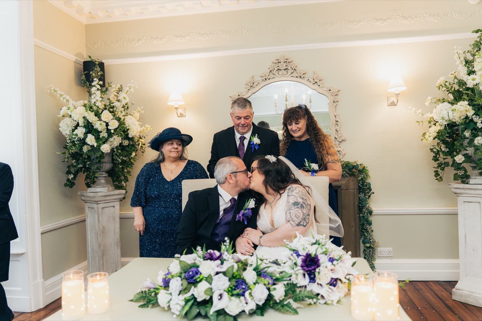 First kiss at the signing table in the Ashton Lodge ceremony room