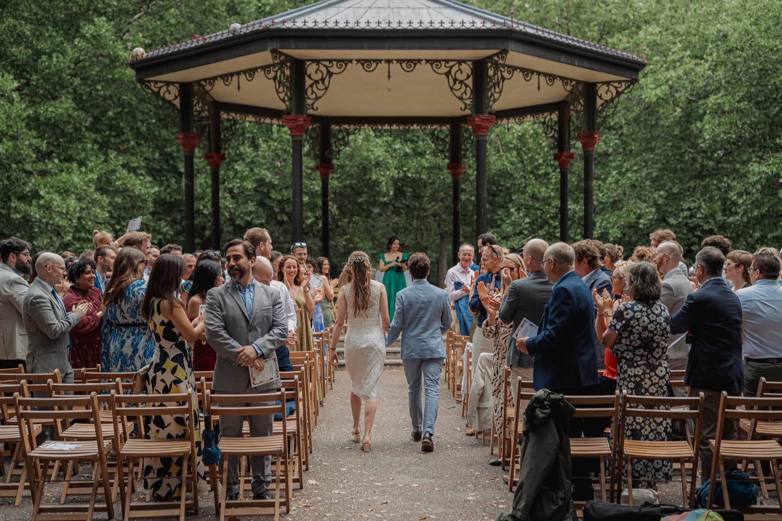 Liz and Sean leaving their ceremony at the Battersea Park bandstand