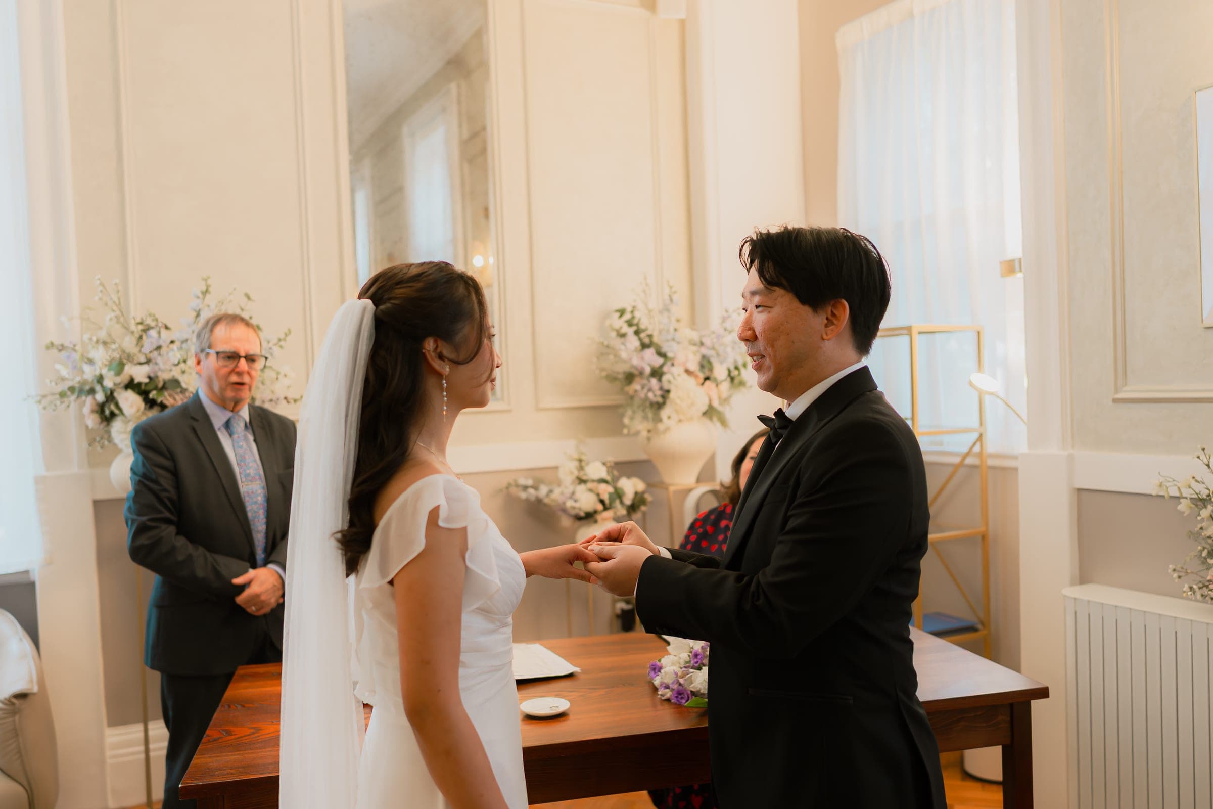 Ring exchange during a wedding ceremony in the Brydon Room at Chelsea Old Town Hall