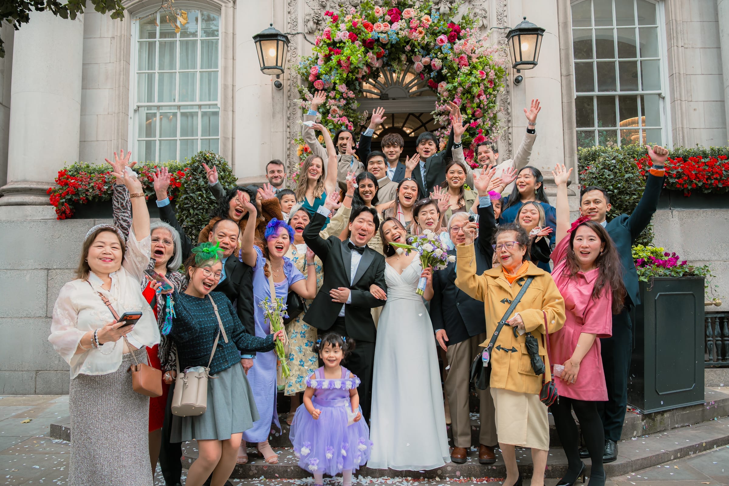 A wedding group gathered on the steps of a London town hall