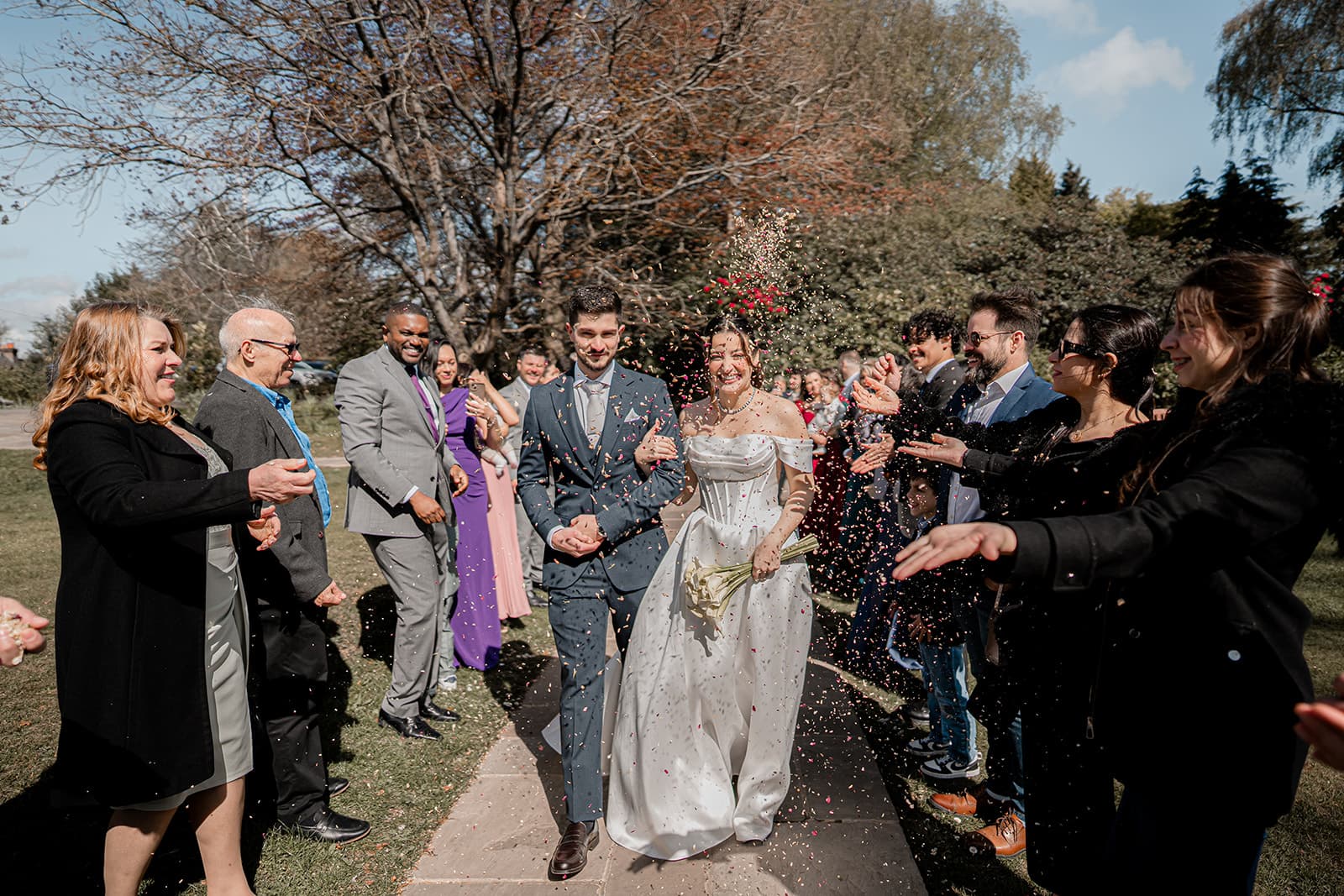 Bruno and Barbara walking through confetti at Highley Manor, Haywards Heath