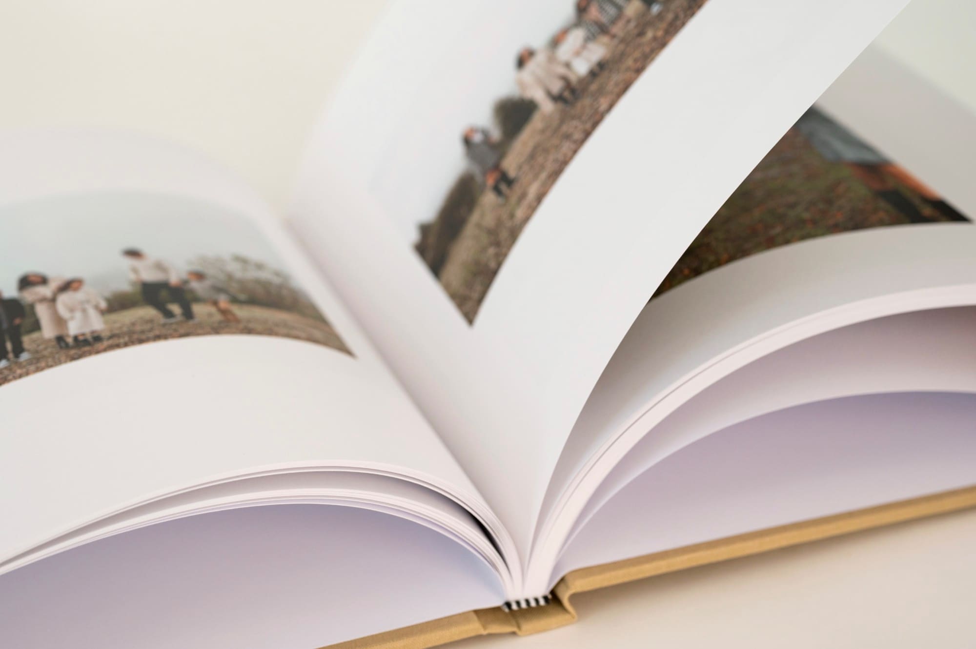 A wedding album lying open, its printed pages fanned
