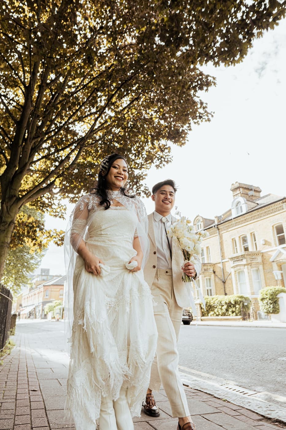 Wedding couple walking through the streets of London, documentary wedding photography by Evocation Photography